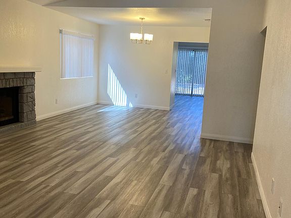 Gorgeous new flooring in the spacious great room. Features include high ceilings, with new can lighting installed. Fireplace.