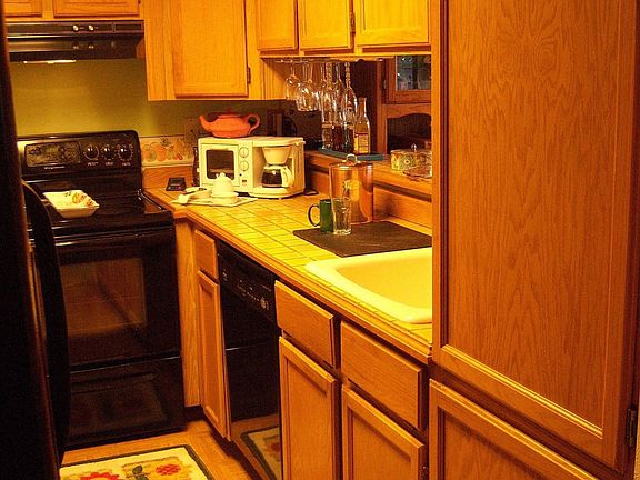 Another view of kitchen.  Plenty of cabinet space and extra deep pantry.