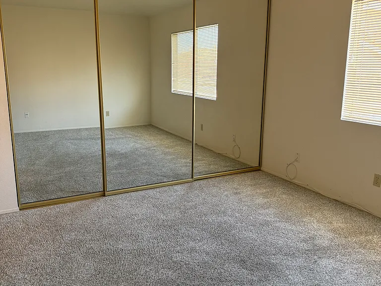 master bedroom w/mirrored wardrobe doors