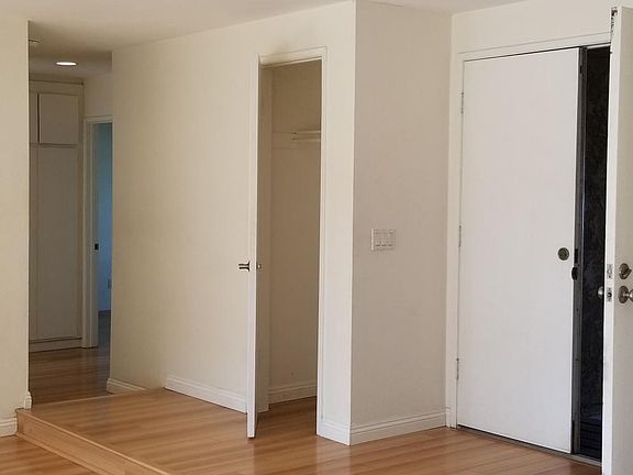From kitchen counter looking at the entrance double doors and to the left is a coat closet with the hallway to the bedrooms.