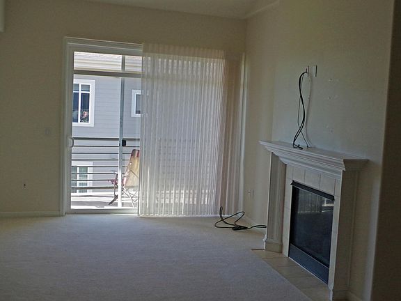 Large living room with gas fireplace and ready for flat scre