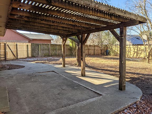 Pergola and oversized concrete patio with fully privacy fenced yard.