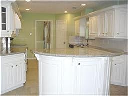 Gourmet kitchen features beautiful granite counters, S.S.appliances, upgraded range, over sized isla