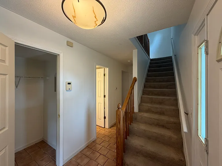Coat closet, half bath & hall to laundry & kitchen