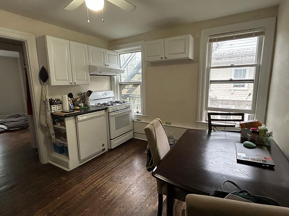Eat in kitchen with gas range, dishwasher, stainless steel restaurant grade sink & cabinet, and silver refrigerator. Shelving unit (not in photograph) available for tenant's use for under the high cabinets.