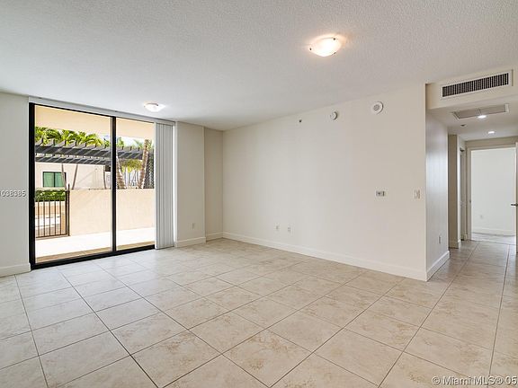 Thru the sliding glass doors you can see your own walled patio area and the gate to proceed to the promenade Pool-deck. To the right is the hallway to the first Bdrm & the Master Bedroom.