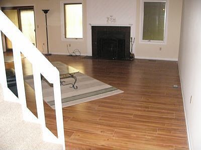 Great room with fireplace, ceiling fan. New floor, paint. 
