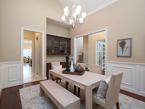 Formal dining with high ceilings, and rich base boards with wainscoting, and double crown molding.   Wood cabinets and granite counter along with glass uppers appoint the butler's pantry.   Great to display fine china or serve dinner for family and friend