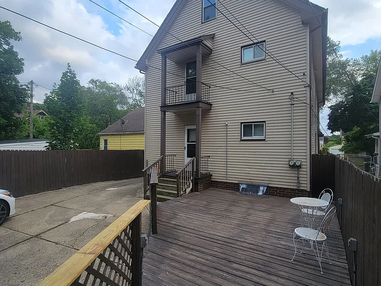 Fenced backyard with deck