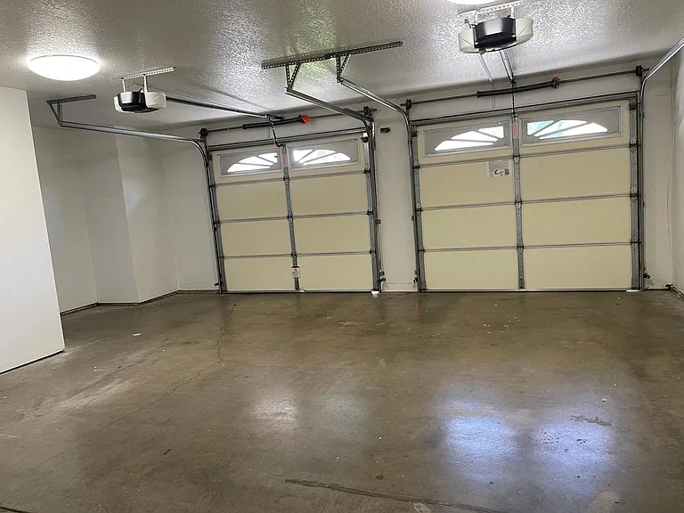2 car garage and additional small bench area or to be used as storage space, new Garage door openers