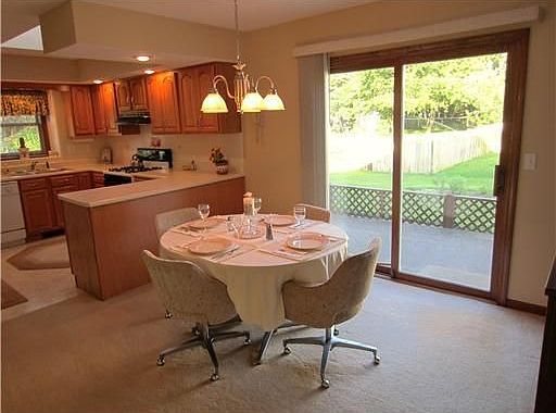 Lovely sun porch with retractable awning off dining room