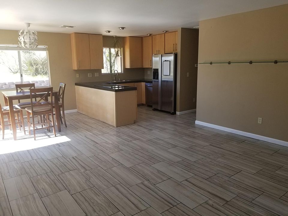 House is otherwise unfurnished. One inch curtain rods are installed in each bedroom. The rear of the house have spectacular views of the Joshua Tree National Park. The mountains rise majestically just 1/4 mile away.
