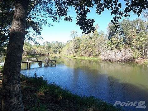 Take a walk on the dock & enjoy the serene setting w/five acre lake.