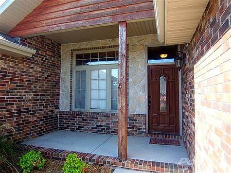 Beautiful covered porch with stone accents.