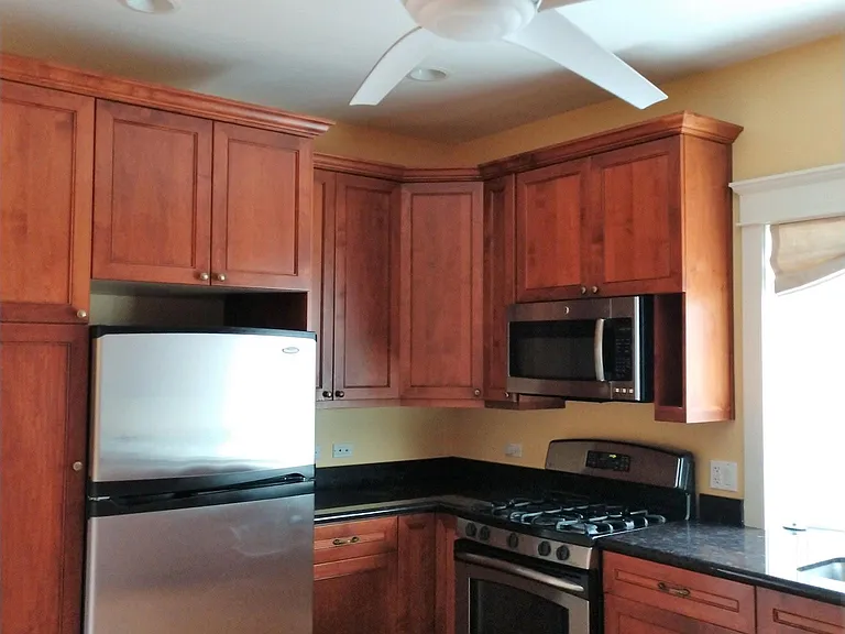 New kitchen with Maple wood cabinets and recessed lightening