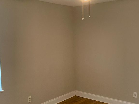 Second bedroom with ceiling fans, hardwood flooring throughout and huge closets featuring two inch wooden blinds