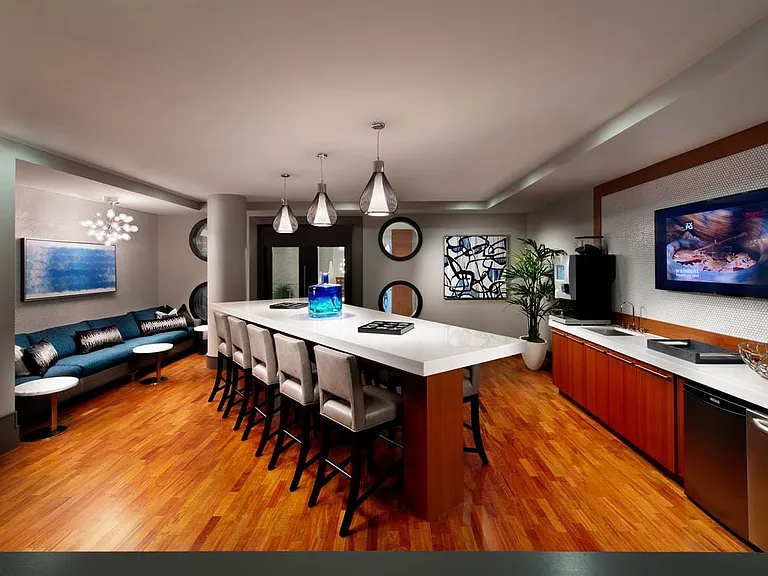 Resident lounge with entertaining kitchen, flat screen television and common area seating