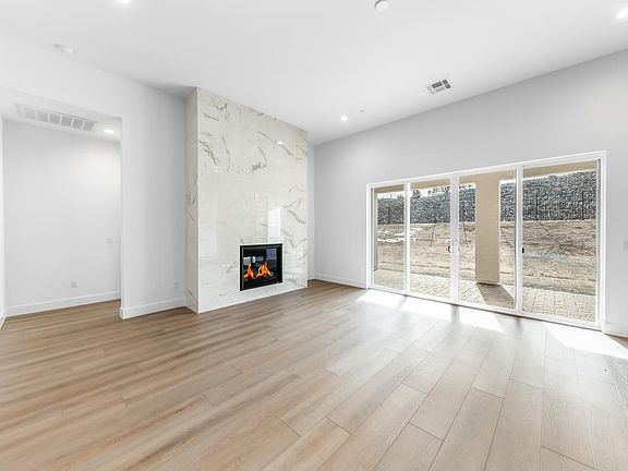 Cozy fireplace in the great room with an abundance of natural light