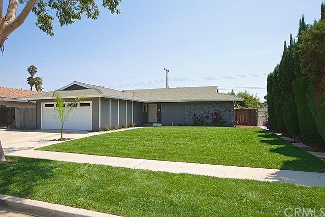 Large frontyard with new sprinklers/drains/sod/plants.