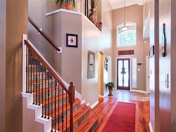 From the full leaded glass door to the color of paint, the entry welcomes like none other. Slate kick-plates on the stairway impeccably accent the wrought-iron balusters. On the left is the powder room, right are study and dining.