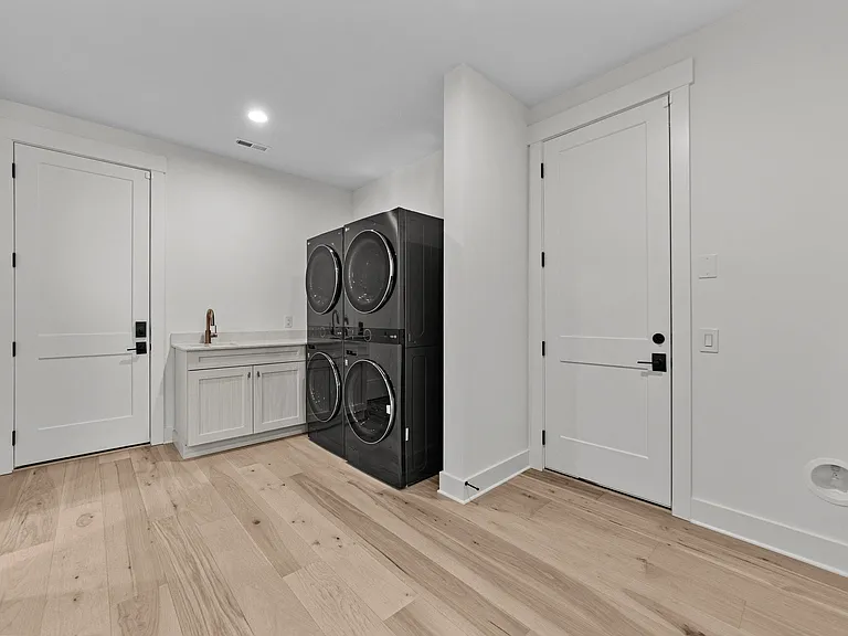 Double LG washer and dryer in the "do zone" space of the home with sink and folding area