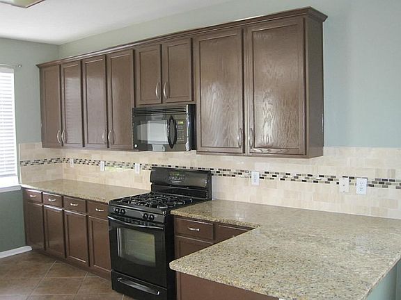 Kitchen with new granite and tile backsplash. Lots of counter space and a HUGE pantry.