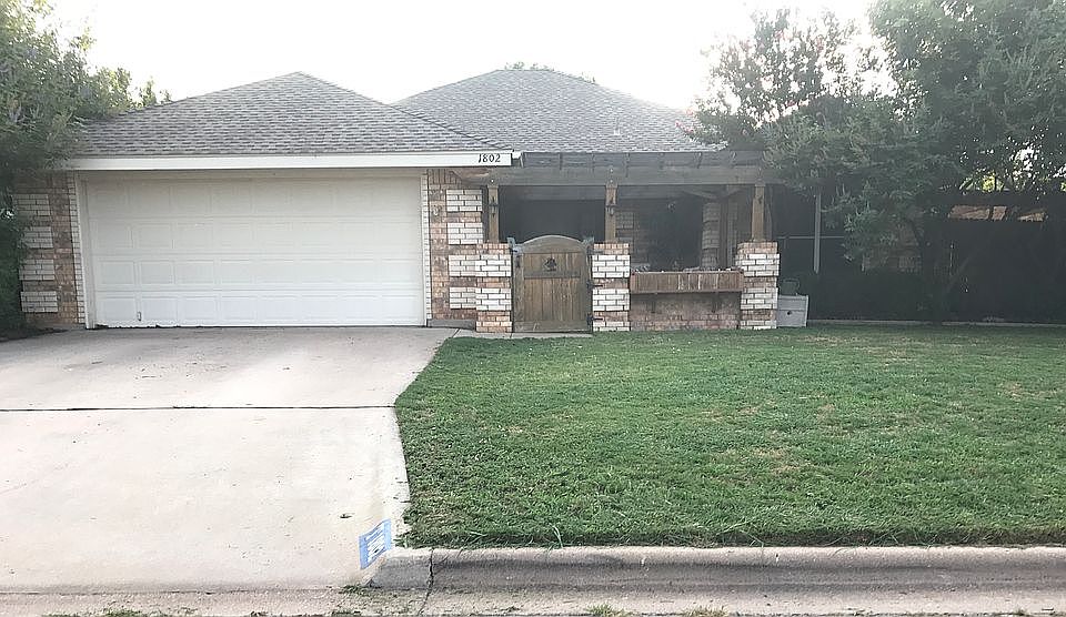 Front lawn, garage, purgola