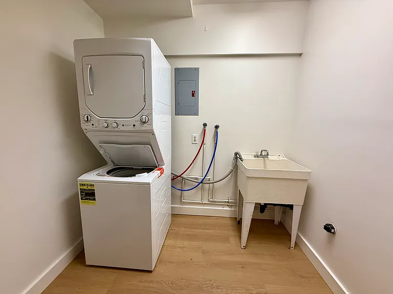 In-unit washer & dryer located behind the entrance stairs.