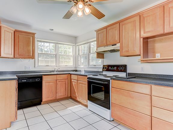 Kitchn: maple cabinets, Corian counters & tile flr