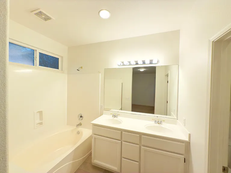 Luxurious master bathroom with dual sinks, a soaking tub, and ample space for relaxation and comfort!