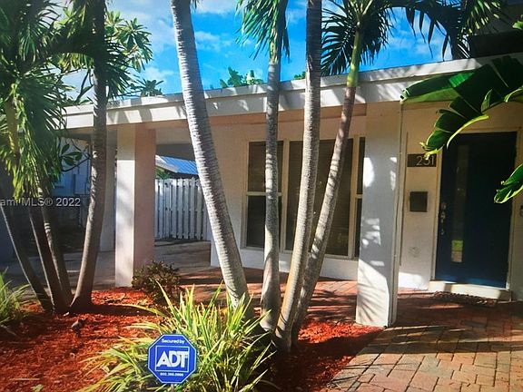 Covered Carport with circular driveway accomodating 3 vehicles.