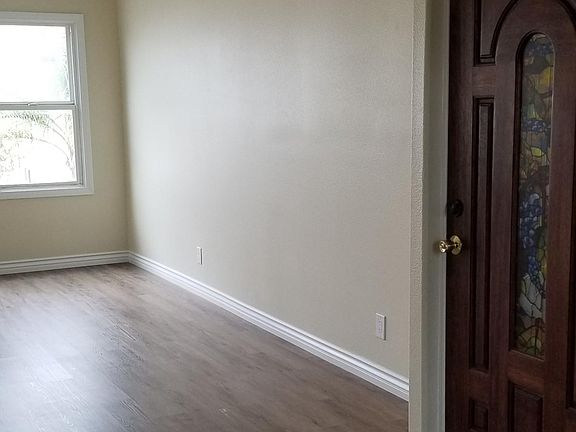 A view of the entry door and the living room