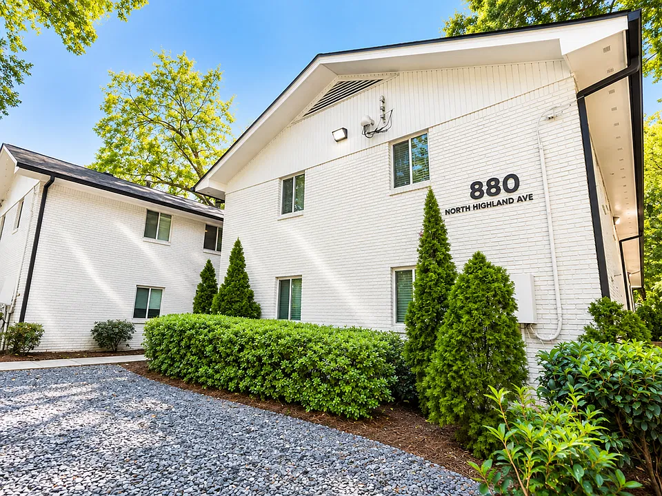 White-brick exterior and prominent 880 North Highland Avenue signage at this Virginia-Highland apartment property in Atlanta.