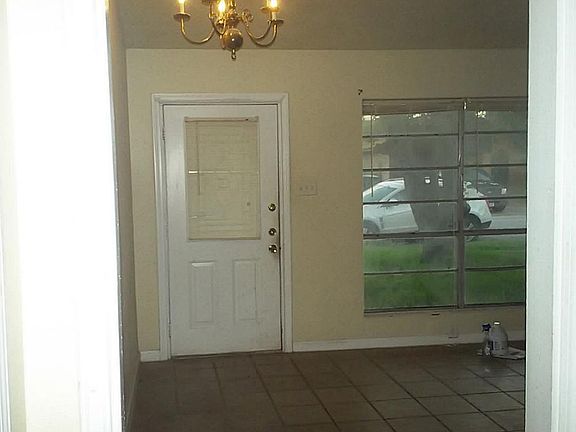 Front door leads into living room with vaulted celling.