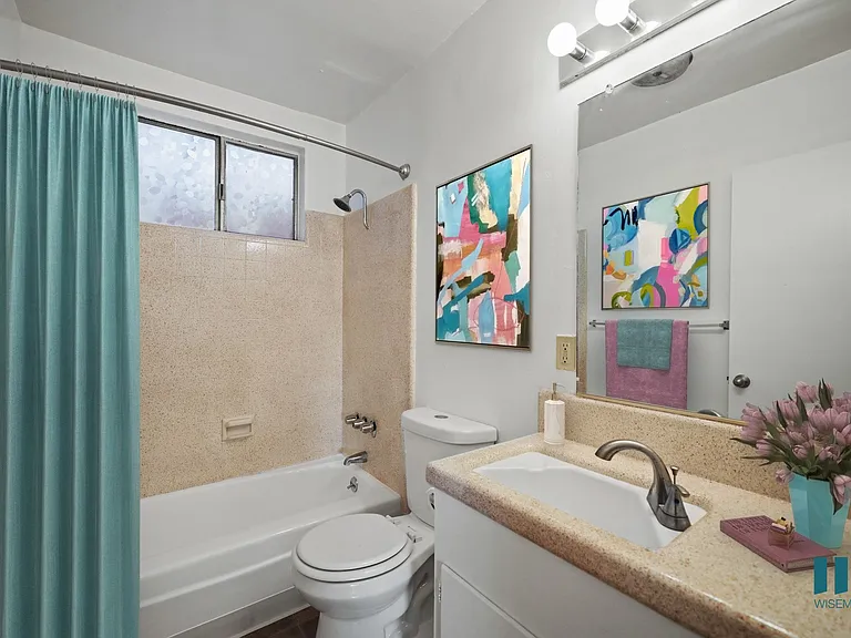 Bathroom with Shower Bath, Window, and Vanity Cabinet Storage