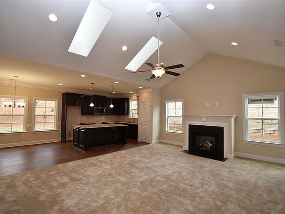 Family room with gas log fireplace and skylights