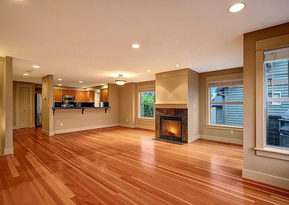 Spacious living room with kitchen and gas fireplace.