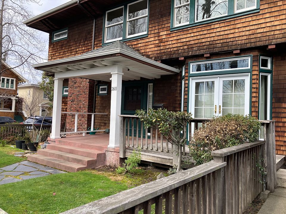 Exterior of downstairs unit with large entry area. View or porch/deck and front garden