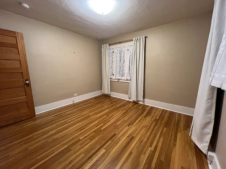 North bedroom currently with updated drapes and sheers