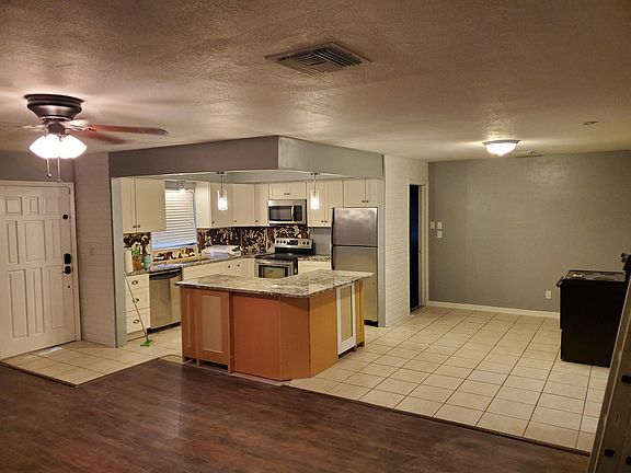 Far side of living room looking into kitchen and dining area. Backsplash is now completed (pictured later), back of island will be completed this week.