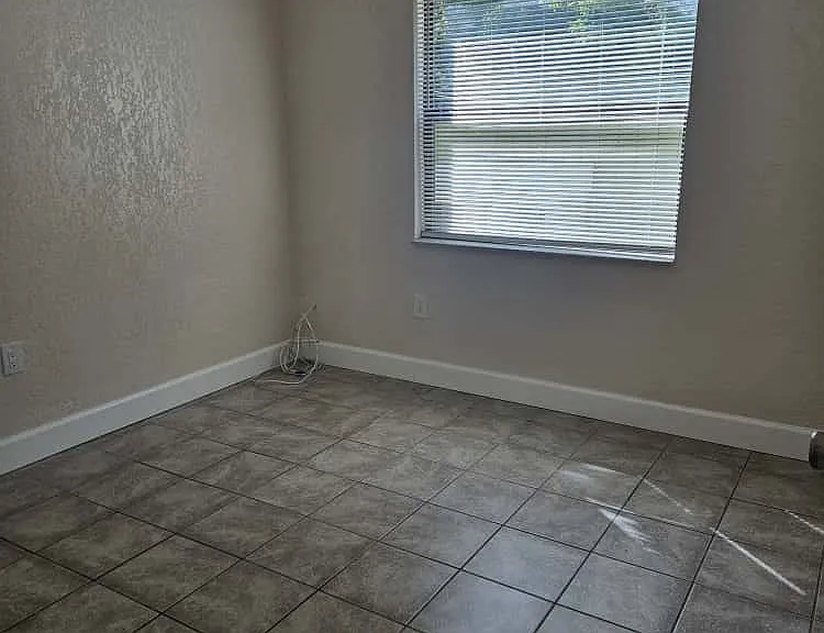 Bright second bedroom with window providing natural light