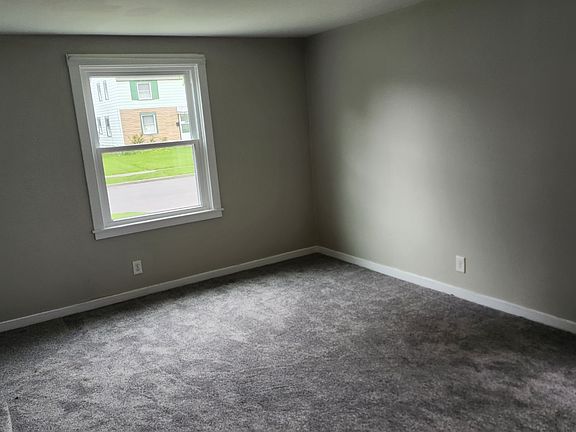 Living room with brand new carpet and front window