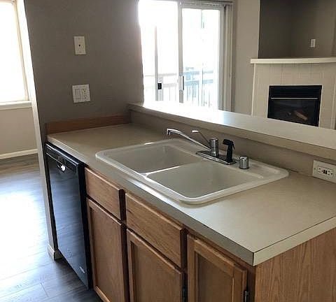 In the kitchen with the living room to the right and dining room to the left.