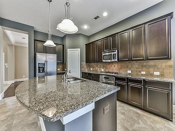 Plenty of counter space and room for bar stools at the breakfast bar/island.