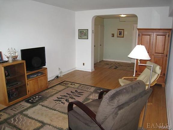 Sunny Living Room with refinished hardwood floors. Room size is 19'-2" x 12'-0"