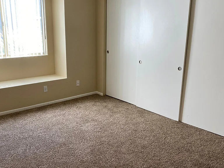 downstairs 2 bedroom - main bedroom with LED ceiling fan, window seat and large closet