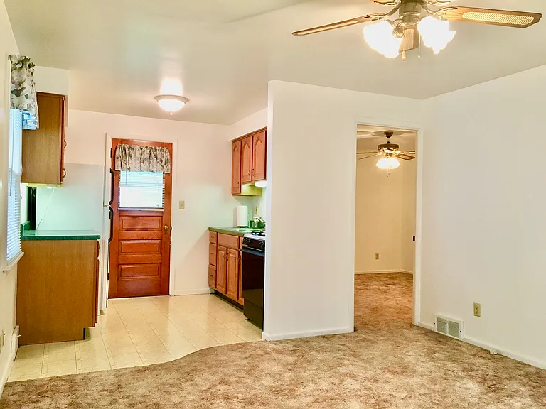 Kitchen and bedroom from living area. 
Carpet recently cleaned throughout.