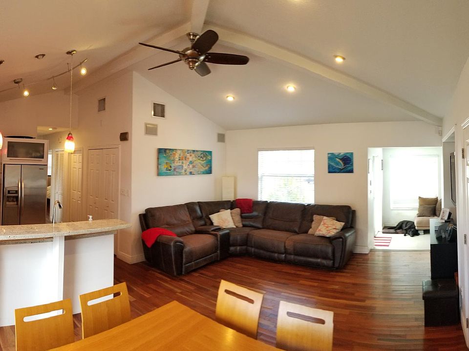 Open concept living/dining room with high ceilings