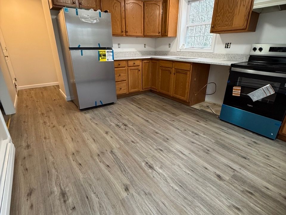 Kitchen with Quartz countertops, Stainless sink and new stainless appliances. Dishwasher and microwave being installed next.