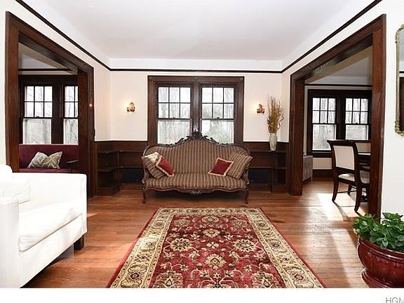 Spacious living room with hardwood floors and magnificent wood trim throughout.